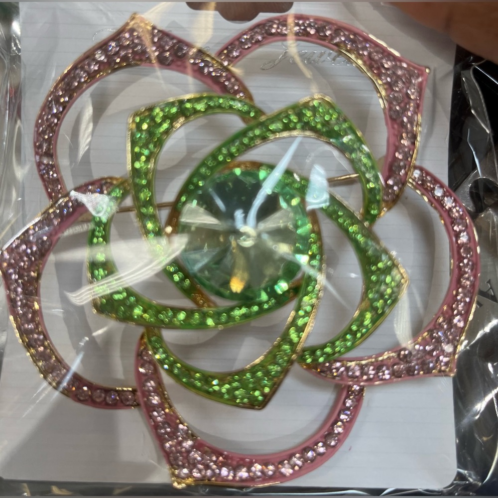 Large flower brooch set in gold tone with pink and green rhinestones
